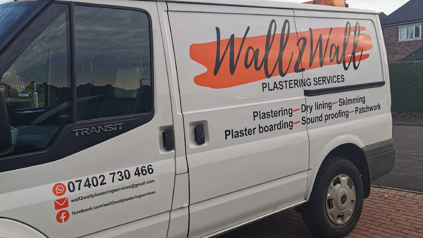 Our white van with the Wall2Wall orange brush-stroke livery, phone number and list of services