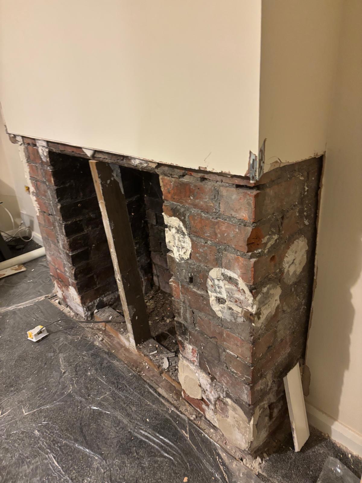 Chimney breast stripped back to bare brick