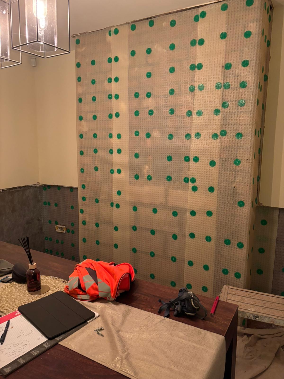Damp course membrane fixed to the wall with plugs